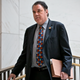 Florida representative Alan Grayson wears a red, white, and blue peace sign tie to a closed-door meeting on Syria in 2013.